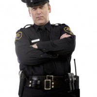 Male police officer with crossed arms